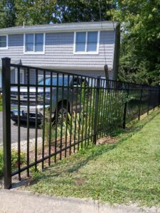 A sleek black metal security fence installed around a residential property by Zelaya Fence in New York City, NY.