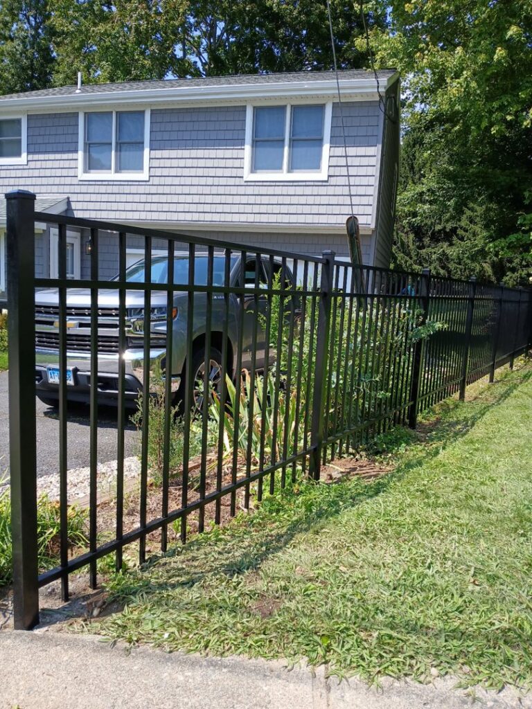 A sleek black metal security fence installed around a residential property by Zelaya Fence in New York City, NY.