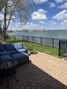 A black metal fence installed along a beautiful waterfront property by Babb Custom Fence in Sioux Falls, SD.