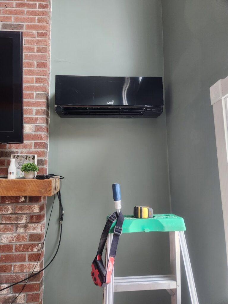 A black mini-split indoor unit installed on a wall with tools nearby, showing an HVAC job by C & C Temp Control in Worcester, MA.