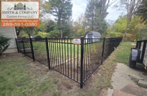 A black ornamental aluminum fence enclosing a residential backyard, installed by Smith & Company Custom Fence LLC in Niles, MI.