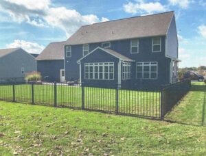 A black ornamental fence enclosing a residential backyard installed by Hitz Fence in Lebanon, PA.
