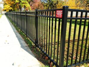 A newly installed black ornamental fence lining a sidewalk, showcasing work by Brodeur-Campbell Fence Co. in Springfield, MA.