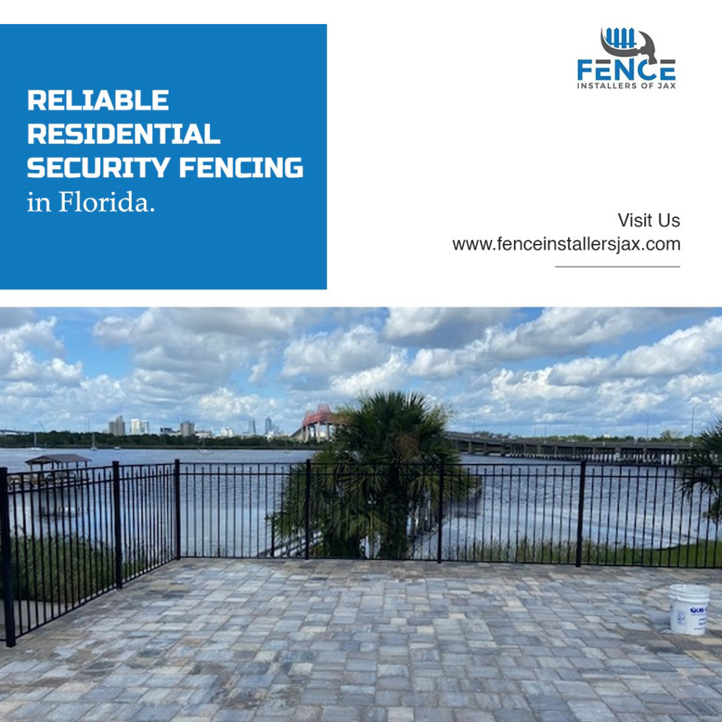 A black ornamental fence along a waterfront property in Jacksonville, FL, installed by Fence Installers of Jacksonville.