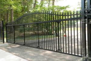 A grand black ornamental iron driveway gate, expertly installed by AVA Fence & Railing LLC in Stamford, CT.