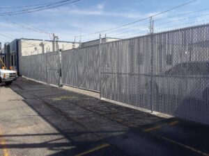 A black ornamental iron fence installed in a backyard with a wooden privacy fence in the background by Best Fence & Gate LLC in Louisville, KY.
