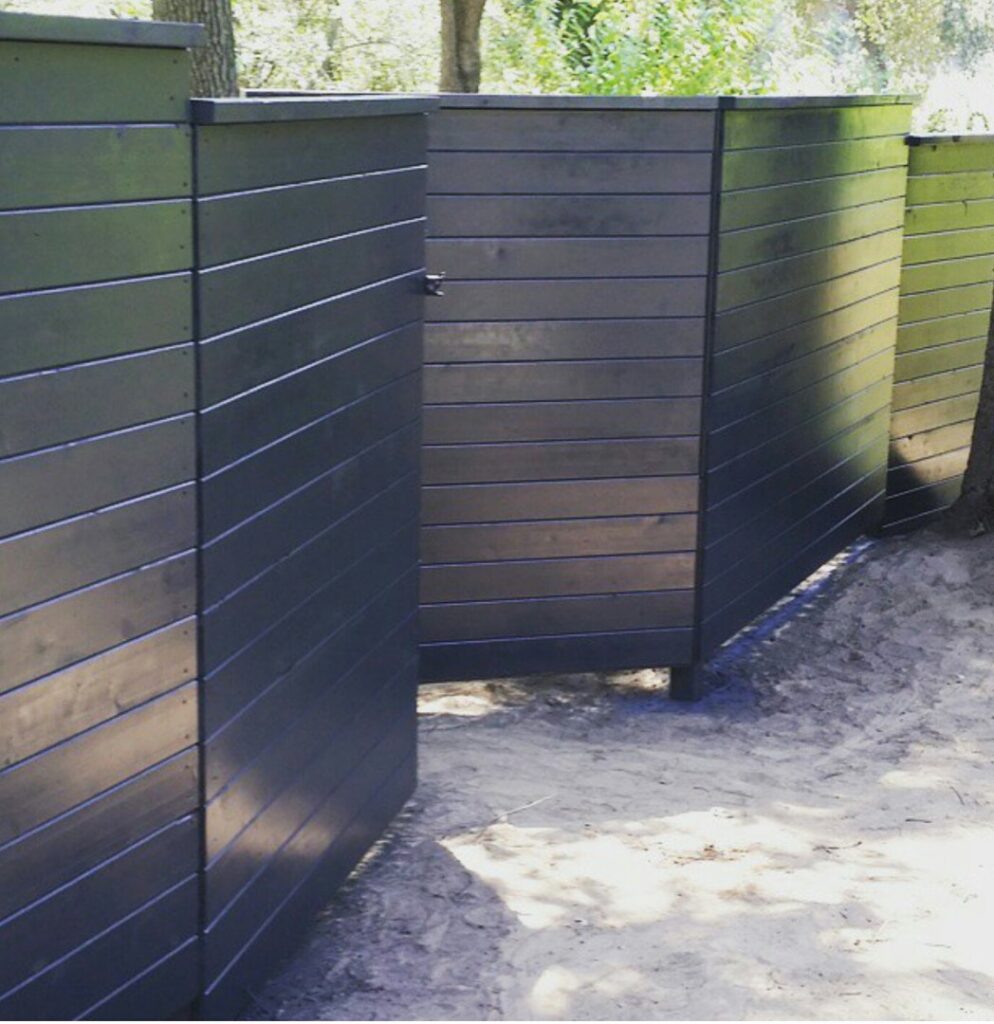 A black ornamental iron fence bordering a baseball field, installed by The Fence Company in Fresno, CA.