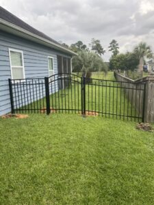 A black ornamental iron fence with a gate installed at a residential property by Crompton Fence Company in Charleston, SC.