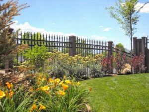 An elegant black ornamental iron fence with decorative posts installed by Stonehenge Fence & Deck in Orem, UT.