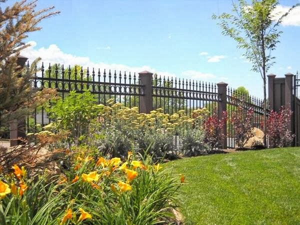 An elegant black ornamental iron fence with decorative posts installed by Stonehenge Fence & Deck in Orem, UT.