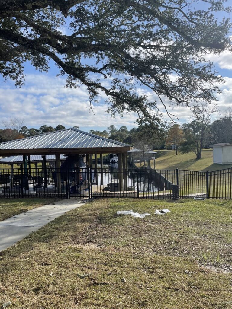 A black ornamental iron fence installed around a park or recreational area by Jaguar Fence LLC in Mobile, AL.