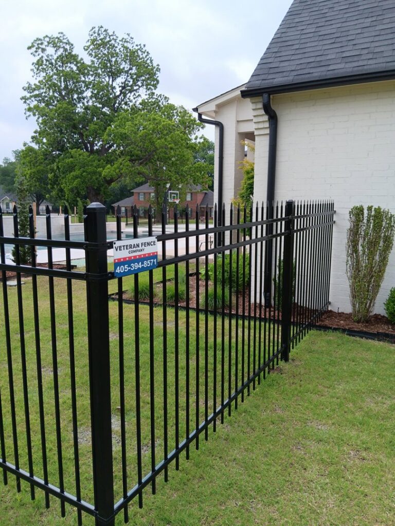A newly installed black ornamental iron fence by Veteran Fence Company LLC in Shawnee, OK.