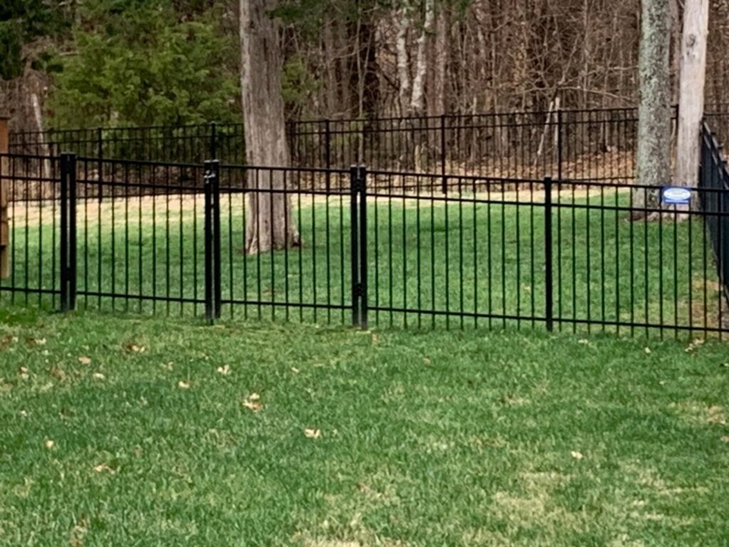 A black ornamental metal fence enclosing a residential yard, installed by America's Fencing in Nashville, TN.