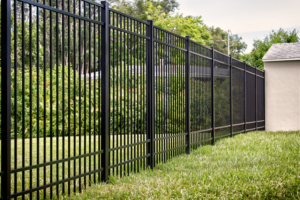 A black ornamental metal fence enclosing a backyard, installed by St. Charles Fence & Deck Company in Saint Peters, MO.
