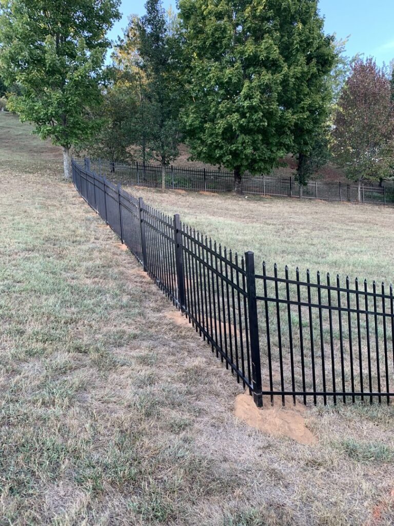 A black ornamental metal fence on a sloped property by Escamilla Fence Co. in Knoxville, TN