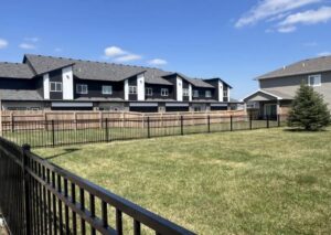 A newly installed black ornamental metal fence surrounding a residential backyard by The GateKeeper Perimeter Fence & Automated Security in Sioux Falls, SD
