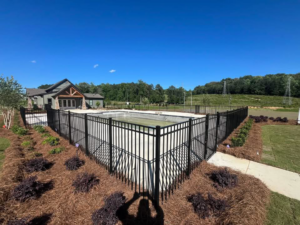 A stylish black ornamental metal fence surrounding a swimming pool area by Alabama Fence & Rail LLC in Birmingham, AL.