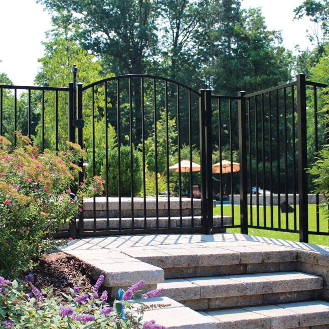 A black ornamental metal fence with a gate enclosing a pool area, installed by Western Fence & Landscape Supply in Caldwell, ID.