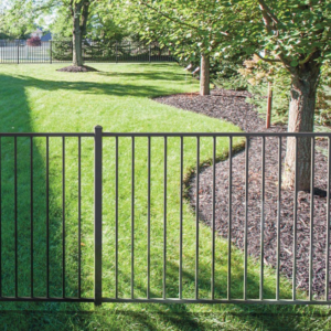 A black ornamental metal fence installed along a property line in a green yard by Western Fence & Landscape Supply in Caldwell, ID.