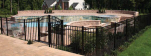 A black ornamental fence installed around a swimming pool area by Hitz Fence in Lebanon, PA.