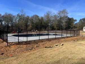 A black ornamental metal fence installed to enclose a swimming pool area by East Georgia Fence in Evans, GA.