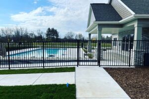 A black ornamental fence enclosing a swimming pool area, installed by Northway Fence in Menomonee Falls, WI.