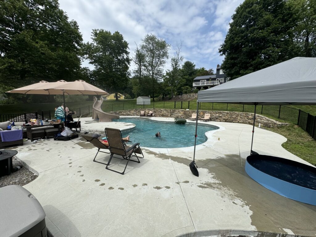 A black ornamental fence securing a pool area by White Eagle Fence Inc in New Haven, CT.