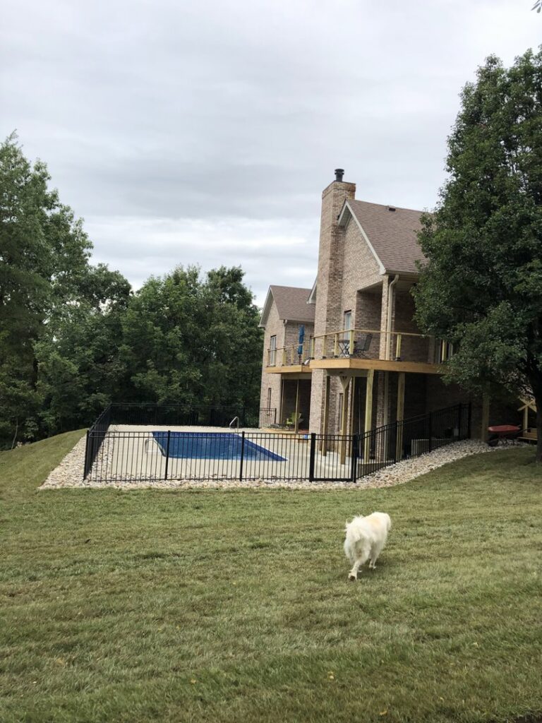 A black ornamental fence installed around a residential swimming pool for safety by Raatz Fence Company in Louisville, KY.