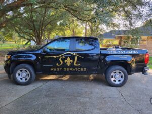 A black pest control truck with S&L Pest Services, LLC branding, ready for service in New Orleans, LA.