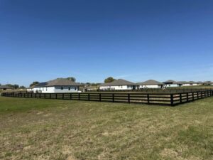 A long black ranch-style perimeter fence installed by Elite Fence and Outdoor of Tampa Bay in Tampa, FL.
