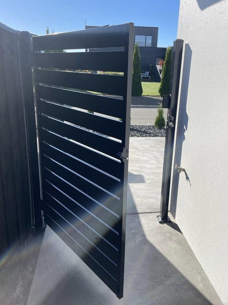 A black slatted gate installed at a residential property, showcasing work by Bespoke Gate Fence & Deck in Christchurch, NZ.
