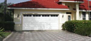 A newly installed black textured garage door on a brick house by Your Other Front Door LLC in Lakewood, CO.