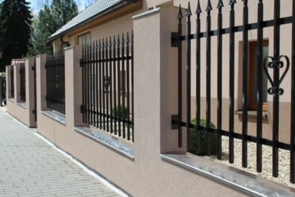An elegant black wrought iron fence with decorative stone pillars installed by Fence Company Chicago in Chicago, IL