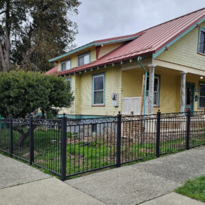 A classic black wrought iron style fence surrounding a residential property, installed by PNW FENCE in Lewiston, ID.