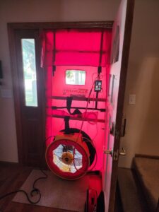A blower door test setup in a doorway, used for energy audits and air leakage testing by Evergreen HVAC Comfort Solutions in Milwaukee, WI.