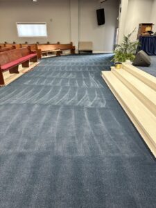 Blue carpet with visible cleaning streaks in a church, cleaned by PROlific Cleaning Services LLC in Indianapolis, IN.