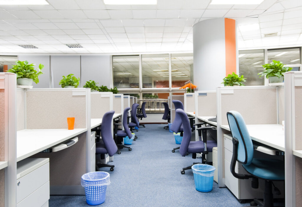 An open-plan office space with new blue carpet installed by Aaron's Facility Services, a carpet contractor in Detroit, MI.