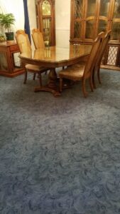 A dining room featuring a stylish blue patterned carpet installed by Floor Designs Unlimited, LLC in Pittsburgh, PA