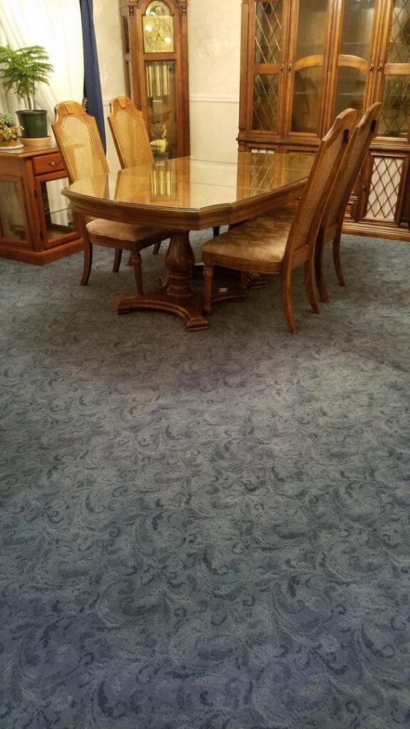 A dining room featuring a stylish blue patterned carpet installed by Floor Designs Unlimited, LLC in Pittsburgh, PA