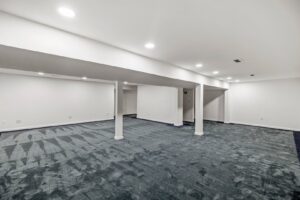 Professional installation of blue patterned carpet in a large room by Nations Best Flooring & Carpet Co. in Livonia, MI.