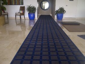 A long blue patterned carpet runner installed in a hallway by Palmetto Carpet Company in Miami, FL.