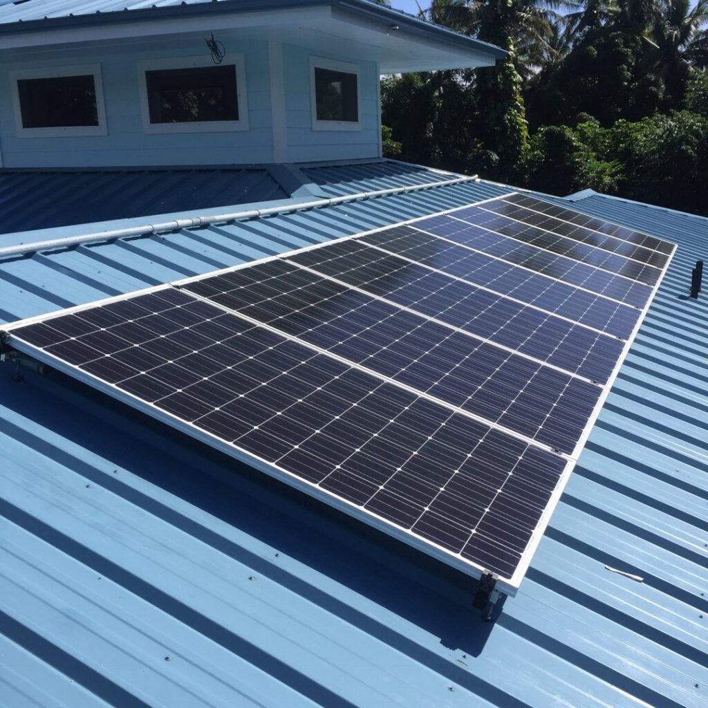 Solar panel installation on a blue metal roof completed by Big Island Electric & Solar in Hilo, HI
