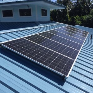 Solar panel installation on a blue metal roof completed by Big Island Electric & Solar in Hilo, HI