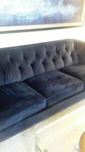 A blue sofa with visible cleaning lines after upholstery cleaning by Superior Carpet Cleaning And Flooring in Dallas, TX