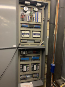 An open building management system (BMS) control panel with Alerton controllers by Allstate Heating & Cooling in Lexington, KY.