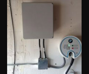 A BMW electric vehicle charger installed with conduit and electrical box by BR Electric in Newcastle, OK.