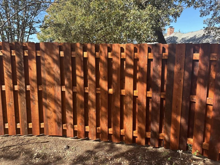 A close-up view of a new board-on-board wooden fence installed by Stevenson Brothers Fencing in Fort Worth, TX