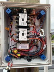 Detailed wiring inside a boat lift electrical control box serviced by A Solid Connection Electrical Services in Brandon, FL.