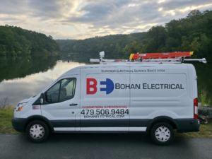 A Bohan Electrical service van with company branding parked by a lake in Bella Vista, AR.