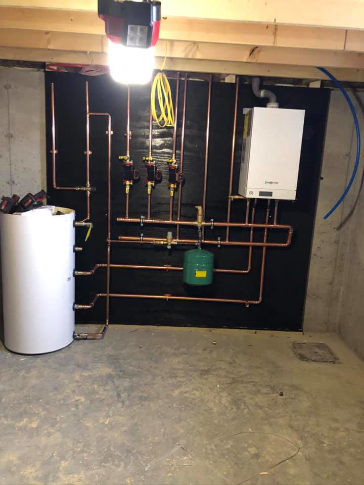 Boiler and hot water tank system with copper piping installed by Ausoli Grace Plumbing & Hvac in South Portland, ME.